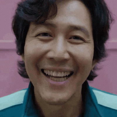 A Close Up Of A Man 'S Face Smiling With His Teeth Showing . GIF