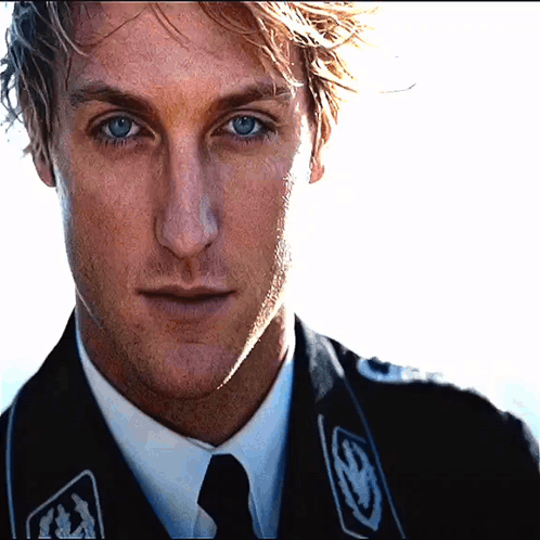 A Close Up Of A Man 'S Face Wearing A Black Jacket GIF