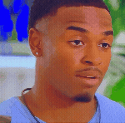A Close Up Of A Man 'S Face Wearing A Blue Shirt GIF