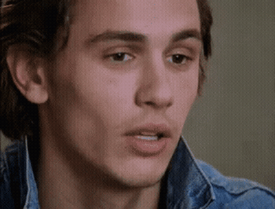 A Close Up Of A Man 'S Face Wearing A Denim Jacket And Making A Funny Face . GIF
