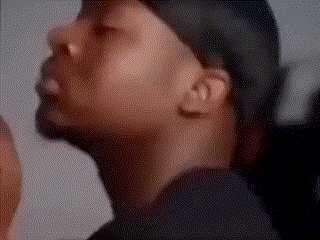 A Close Up Of A Man 'S Face Wearing A Hat And A Black Shirt . GIF