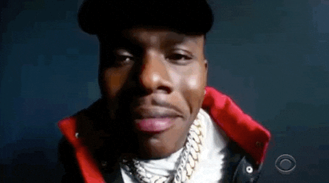 A Close Up Of A Man 'S Face Wearing A Hat And A Red Jacket . GIF