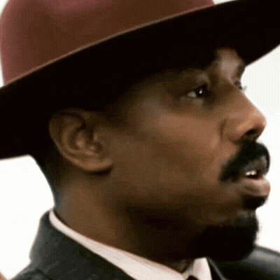 A Close Up Of A Man 'S Face Wearing A Hat GIF
