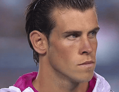 A Close Up Of A Man 'S Face Wearing A Pink Jacket GIF