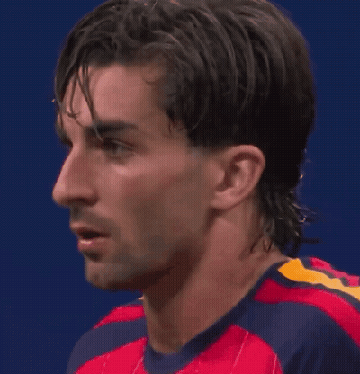 A Close Up Of A Man 'S Face Wearing A Red And Blue Shirt GIF