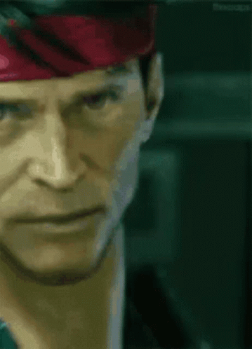A Close Up Of A Man 'S Face Wearing A Red Headband GIF