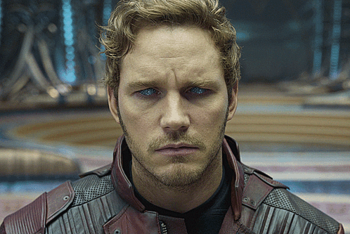 A Close Up Of A Man 'S Face Wearing A Red Leather Jacket GIF