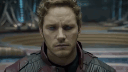 A Close Up Of A Man 'S Face Wearing A Red Leather Jacket GIF