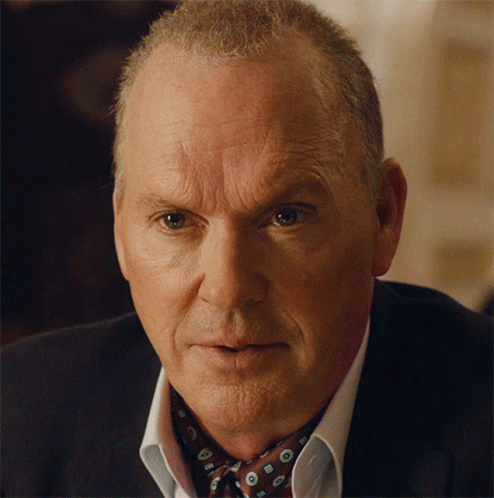 A Close Up Of A Man 'S Face Wearing A Suit And Bow Tie GIF