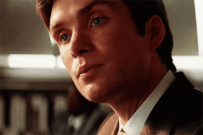 A Close Up Of A Man 'S Face Wearing A Suit And Tie GIF