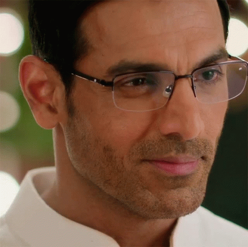 A Close Up Of A Man 'S Face Wearing Glasses And A White Shirt GIF