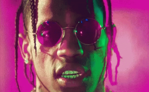 A Close Up Of A Man 'S Face Wearing Sunglasses And Dreadlocks . GIF
