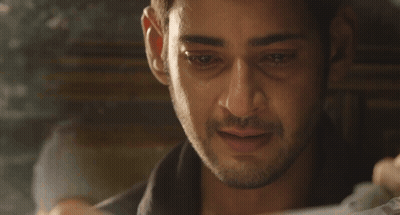 A Close Up Of A Man 'S Face While Looking At A Piece Of Paper . GIF