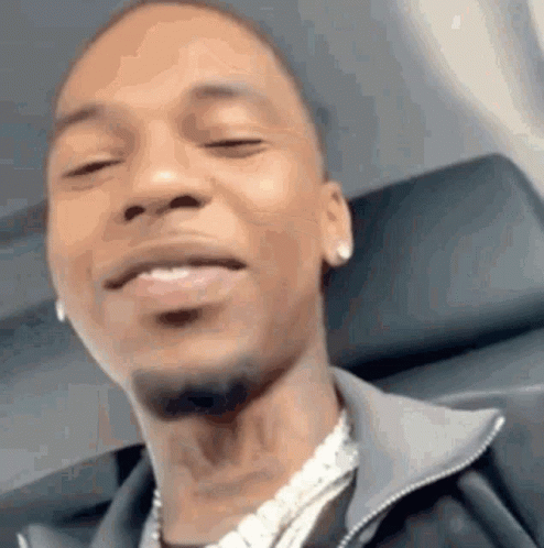 A Close Up Of A Man 'S Face While Sitting On An Airplane With His Eyes Closed . GIF