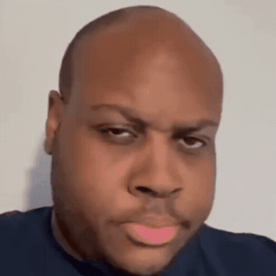 A Close Up Of A Man 'S Face With A Bald Head And A Pink Lip . GIF