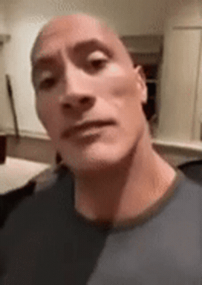 A Close Up Of A Man 'S Face With A Bald Head Making A Funny Face . GIF