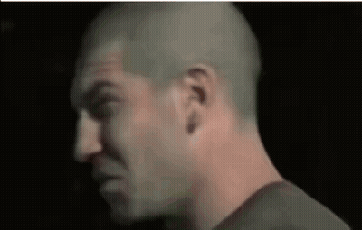A Close Up Of A Man 'S Face With A Bald Head GIF