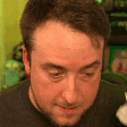 A Close Up Of A Man 'S Face With A Beard And A Black Shirt . GIF