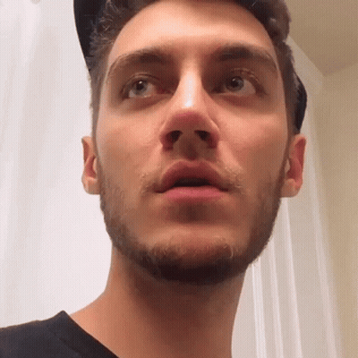 A Close Up Of A Man 'S Face With A Beard And A Hat On . GIF