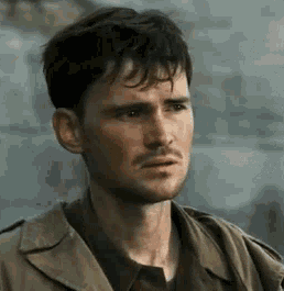 A Close Up Of A Man 'S Face With A Beard And A Jacket . GIF