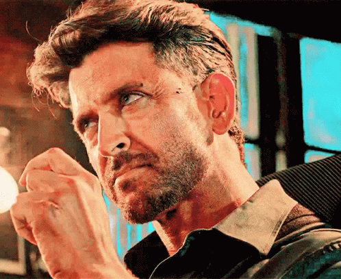 A Close Up Of A Man 'S Face With A Beard And A Piercing In His Ear GIF