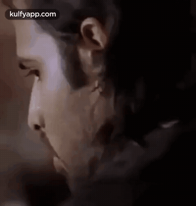 A Close Up Of A Man 'S Face With A Beard And A Piercing In His Ear . GIF