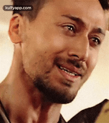 A Close Up Of A Man 'S Face With A Beard And A Smile . GIF