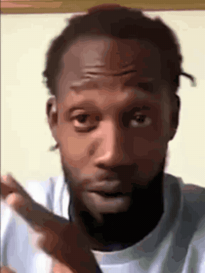 A Close Up Of A Man 'S Face With A Beard And A White Shirt GIF