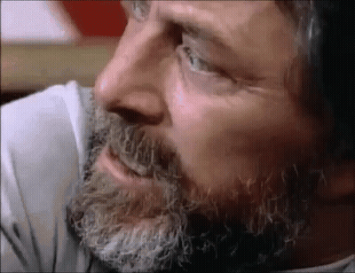 A Close Up Of A Man 'S Face With A Beard And A White Shirt GIF