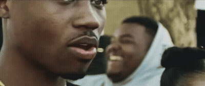 A Close Up Of A Man 'S Face With A Beard And A Woman 'S Head In The Background . GIF