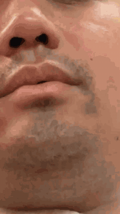 A Close Up Of A Man 'S Face With A Beard And Black Eyes GIF