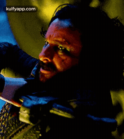 A Close Up Of A Man 'S Face With A Beard And Blood On It . GIF