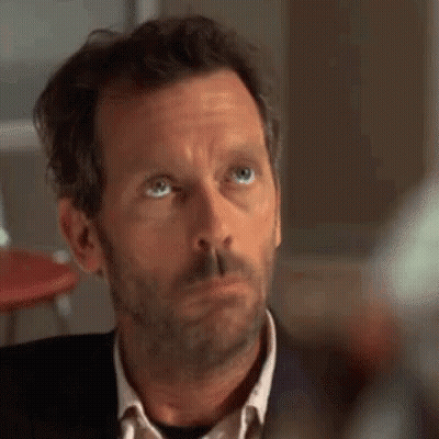 A Close Up Of A Man 'S Face With A Beard And Blue Eyes Looking Up . GIF