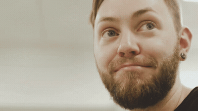 A Close Up Of A Man 'S Face With A Beard And Earring GIF