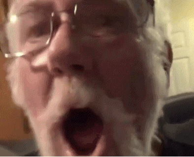 A Close Up Of A Man 'S Face With A Beard And Glasses . GIF