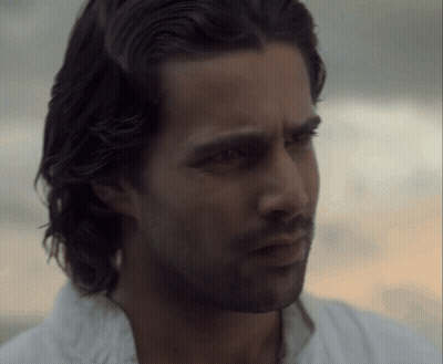 A Close Up Of A Man 'S Face With A Beard And Long Hair GIF