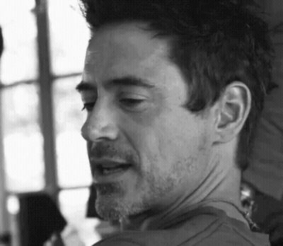 A Close Up Of A Man 'S Face With A Beard And Mustache In A Black And White Photo . GIF