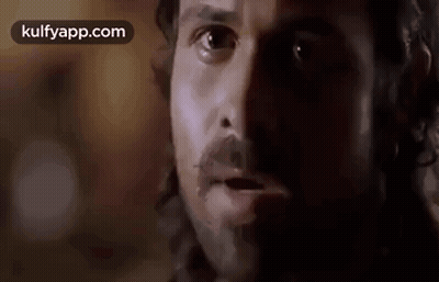 A Close Up Of A Man 'S Face With A Beard And Mustache Looking At The Camera . GIF