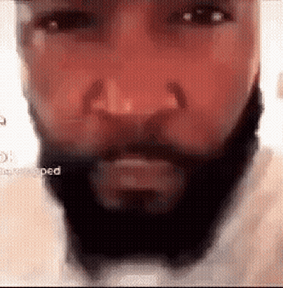 A Close Up Of A Man 'S Face With A Beard And Nose Ring . GIF