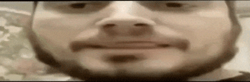 A Close Up Of A Man 'S Face With A Beard And Sunglasses On . GIF