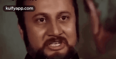 A Close Up Of A Man 'S Face With A Beard And The Words Kulfyapp.com In The Corner GIF