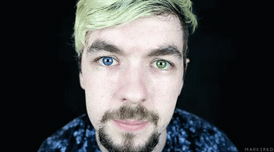 A Close Up Of A Man 'S Face With A Beard And Two Different Colored Eyes GIF