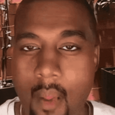 A Close Up Of A Man 'S Face With A Beard Blowing A Kiss GIF
