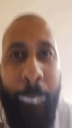 A Close Up Of A Man 'S Face With A Beard . GIF