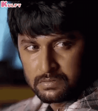 A Close Up Of A Man 'S Face With A Beard Looking At The Camera . GIF