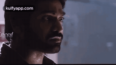 A Close Up Of A Man 'S Face With A Beard Looking At The Camera . GIF