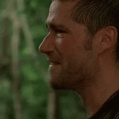A Close Up Of A Man 'S Face With A Beard Looking At The Camera . GIF