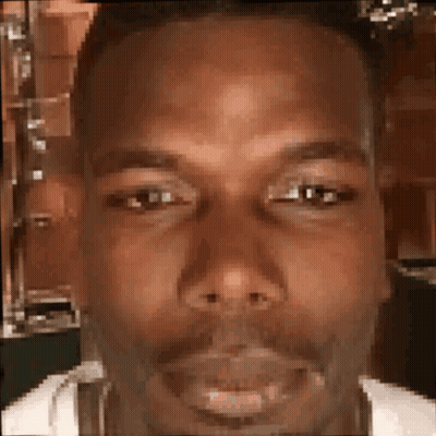 A Close Up Of A Man 'S Face With A Beard Looking At The Camera . GIF