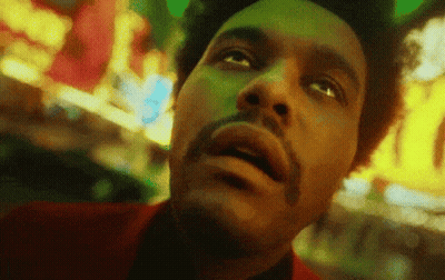 A Close Up Of A Man 'S Face With A Beard Looking Up At The Sky . GIF