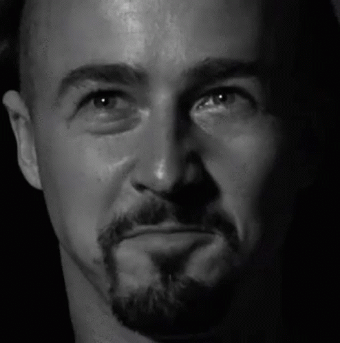 A Close Up Of A Man 'S Face With A Beard Making A Funny Face . GIF